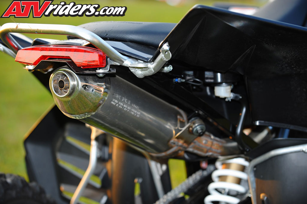 The exhaust on the Suzuki LTR450 is mounted in the center unlike other sport 