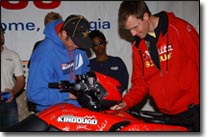 Doug Gust, Ryan Cox sign Commemorative KingQuad 750